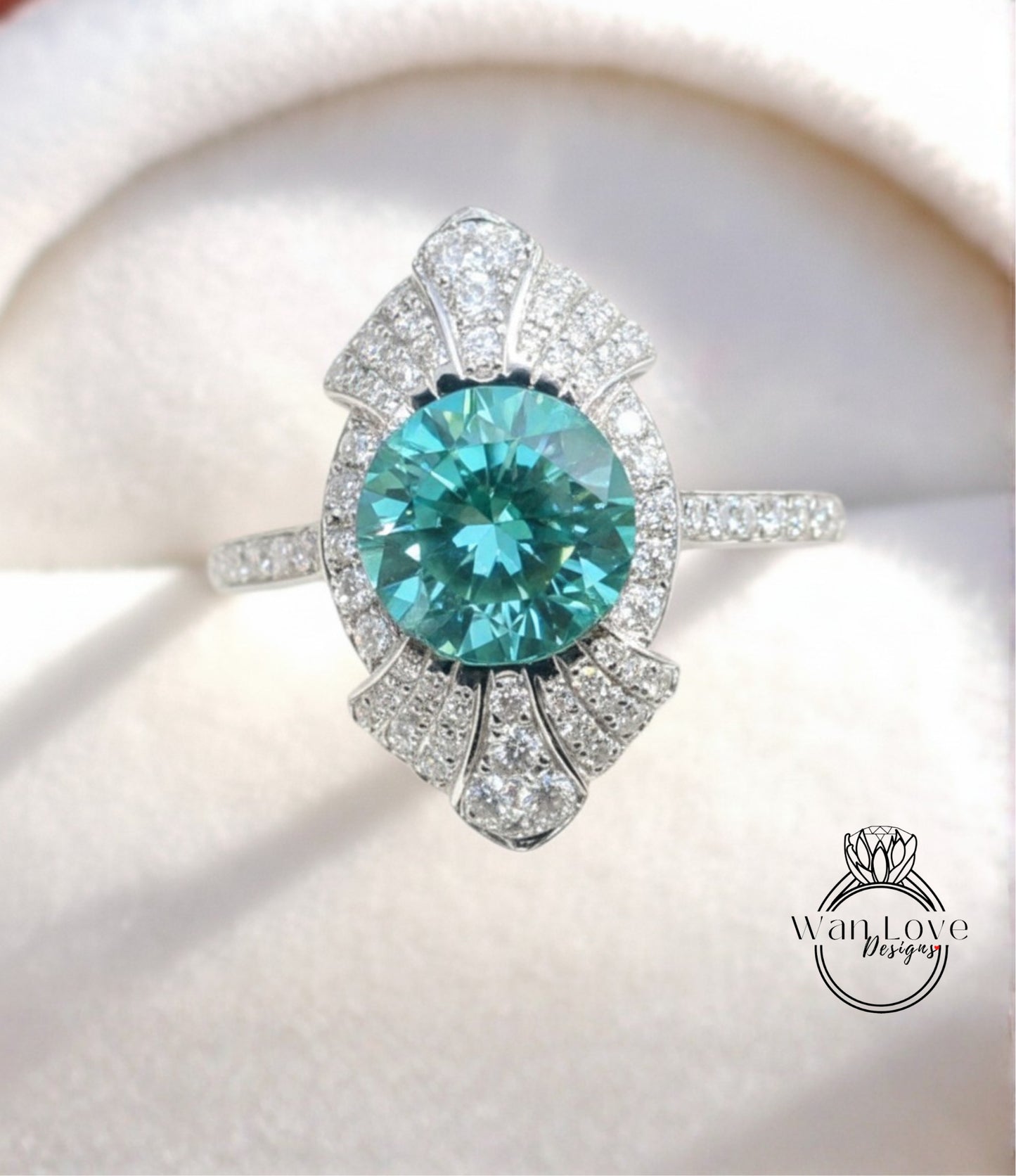 A stunning turquoise diamond ring with a large central gemstone surrounded by smaller diamonds, set in a silver band.