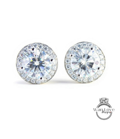 A pair of elegant earrings with large, clear gemstones set in a halo of smaller diamonds, creating a sparkling and sophisticated appearance.