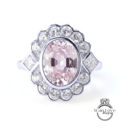 A ring with a large oval-shaped gemstone surrounded by smaller diamonds, set in a silver band.