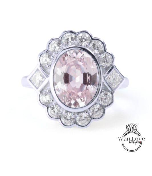 A ring with a large oval-shaped gemstone surrounded by smaller diamonds, set in a silver band.