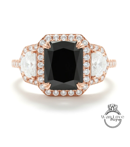 A rose gold ring with a large black diamond as the centerpiece, surrounded by smaller diamonds.
