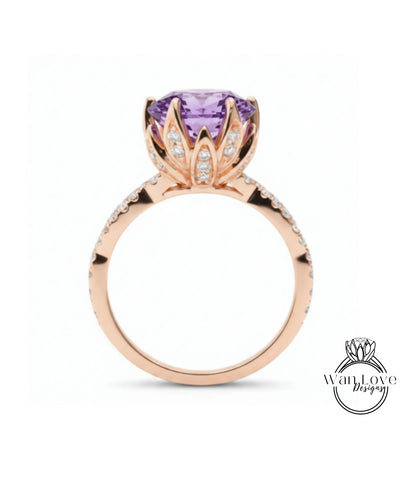A rose gold ring with a large purple gemstone, likely a diamond, at the center.
