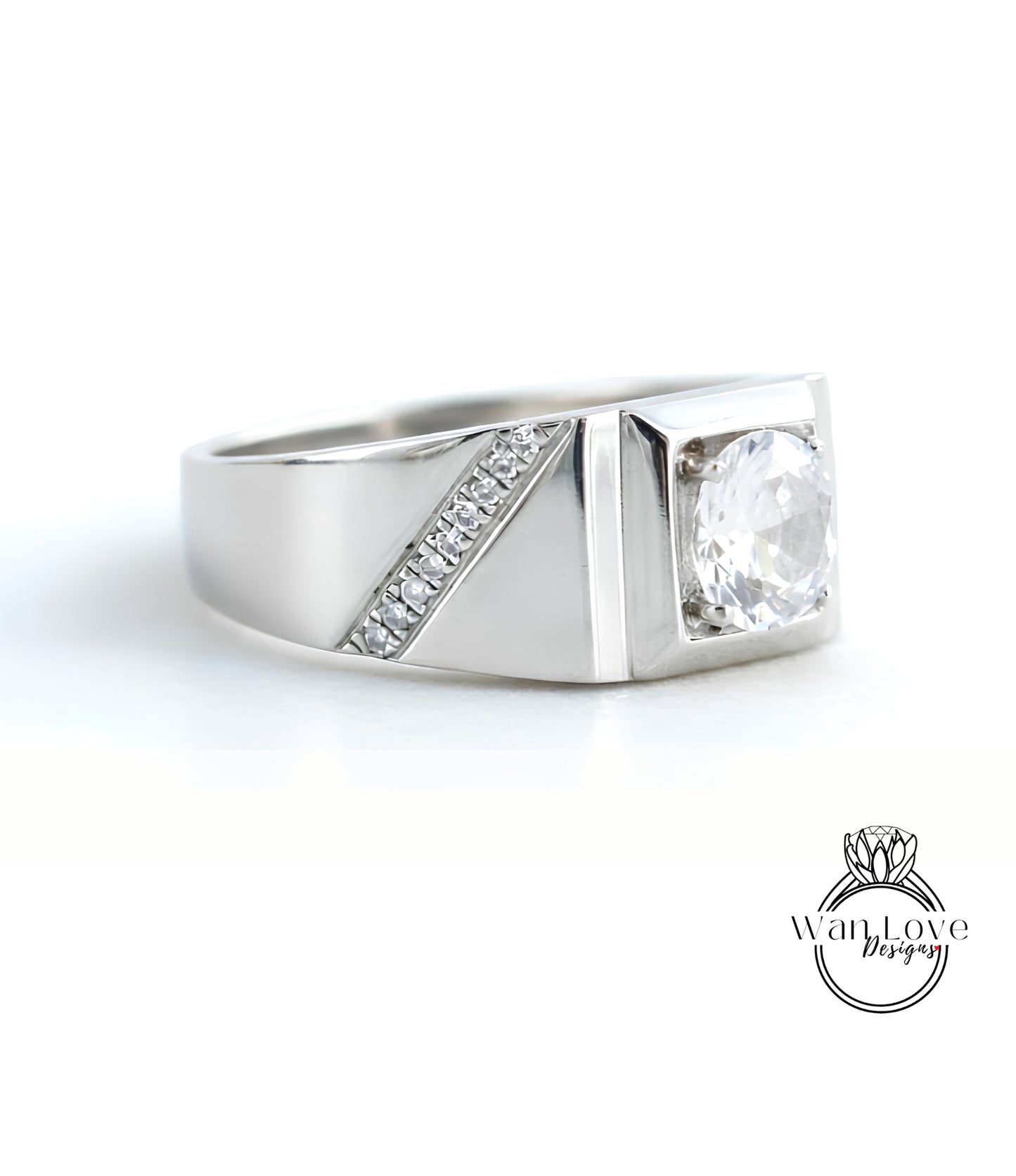 A silver ring with a large central diamond and a smaller diamond accent on the side.