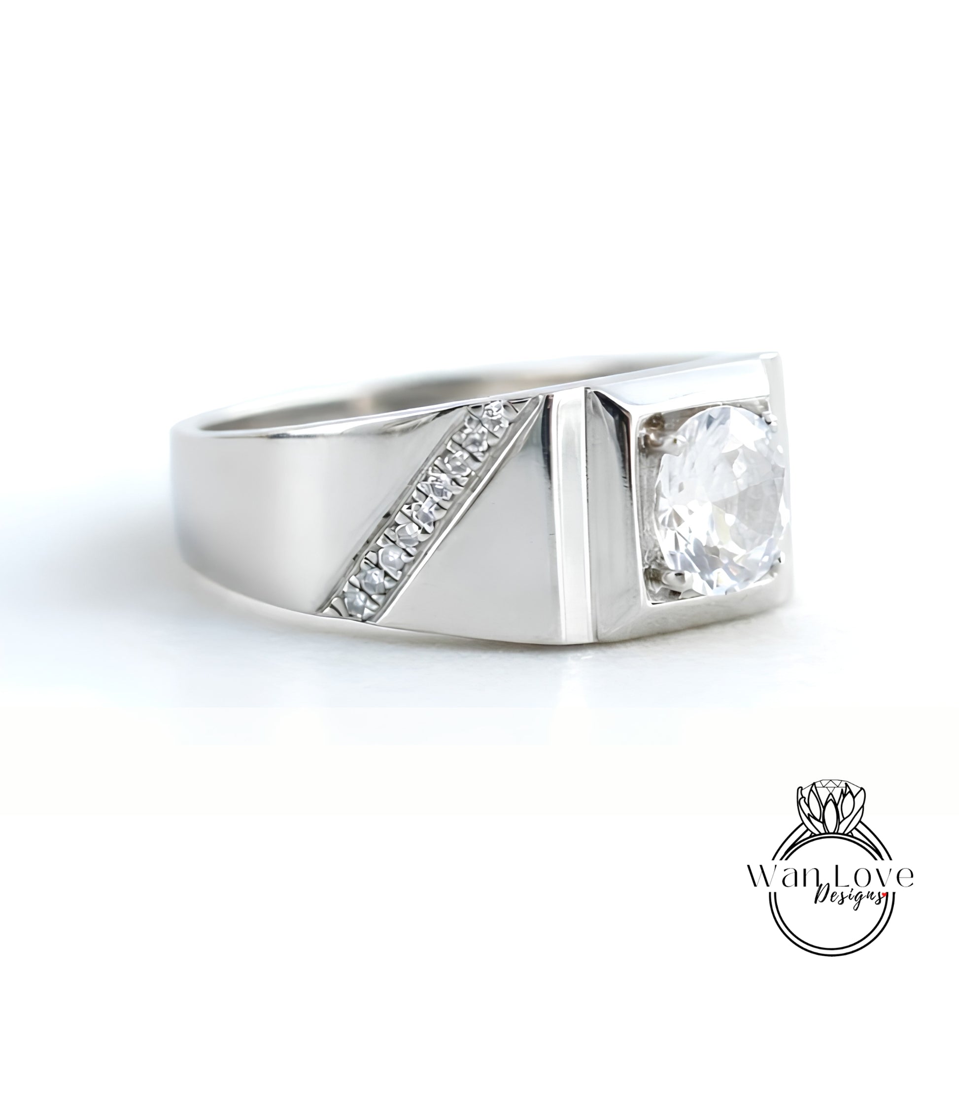 A silver ring with a large central diamond and a smaller diamond accent on the side.