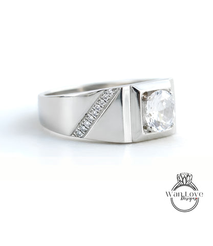 A silver ring with a large central diamond and a smaller diamond accent on the side.