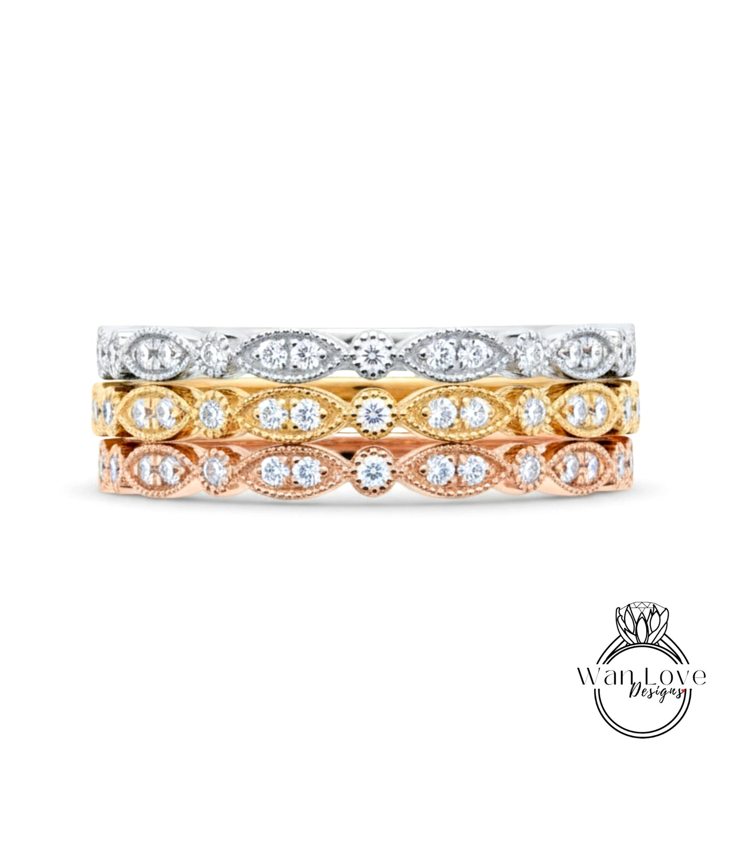 A stack of three rings with different colored gemstones set in the center.