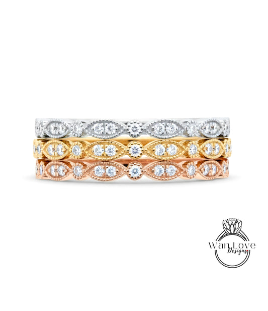 A stack of three rings with different colored gemstones set in the center.