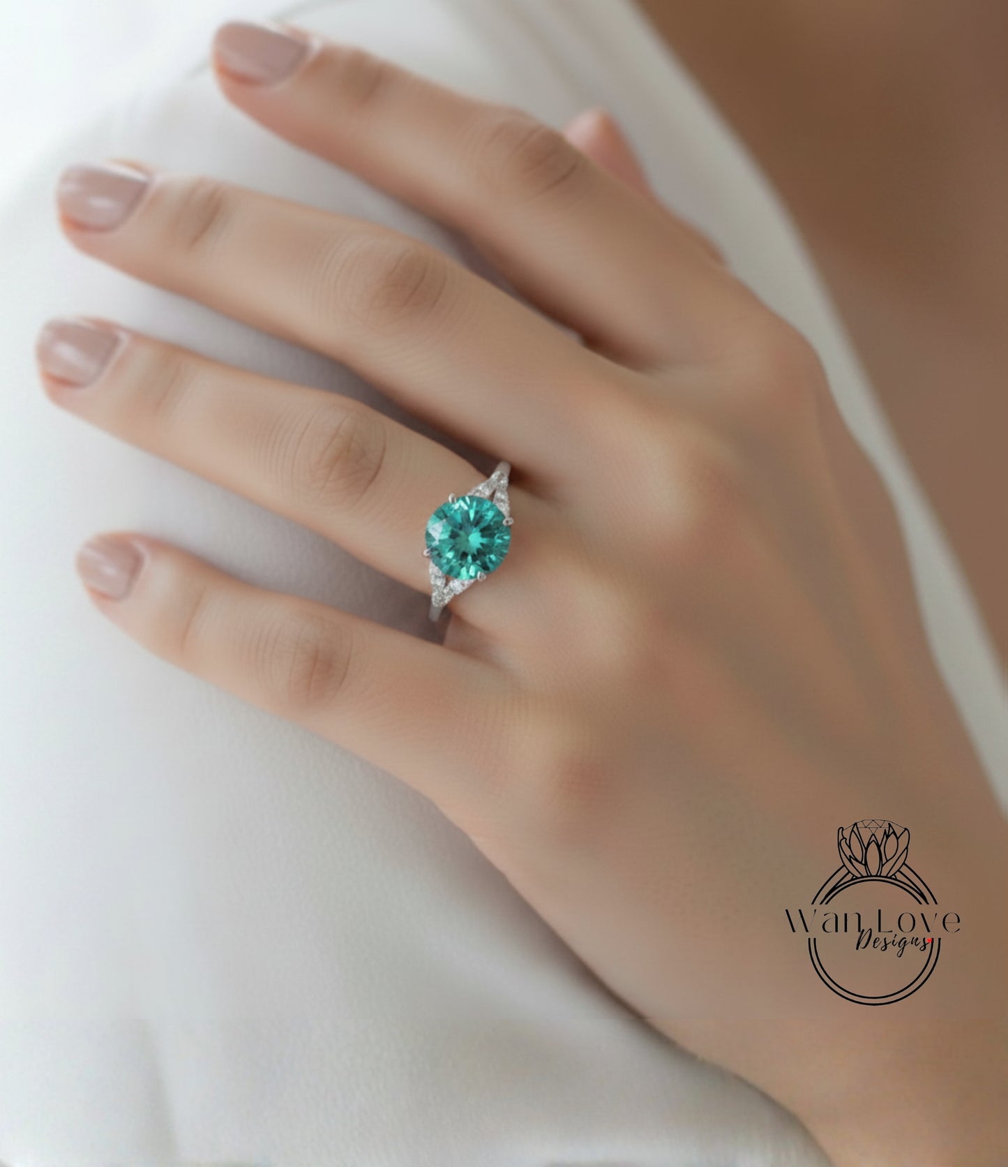 A close-up of a hand wearing a ring with a large, green gemstone.