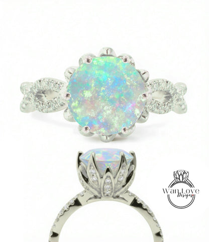a silver ring with a large, round opal gemstone set in a decorative metal band.