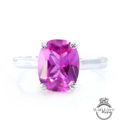 A ring with a large, oval-shaped, pink gemstone set in a silver band.