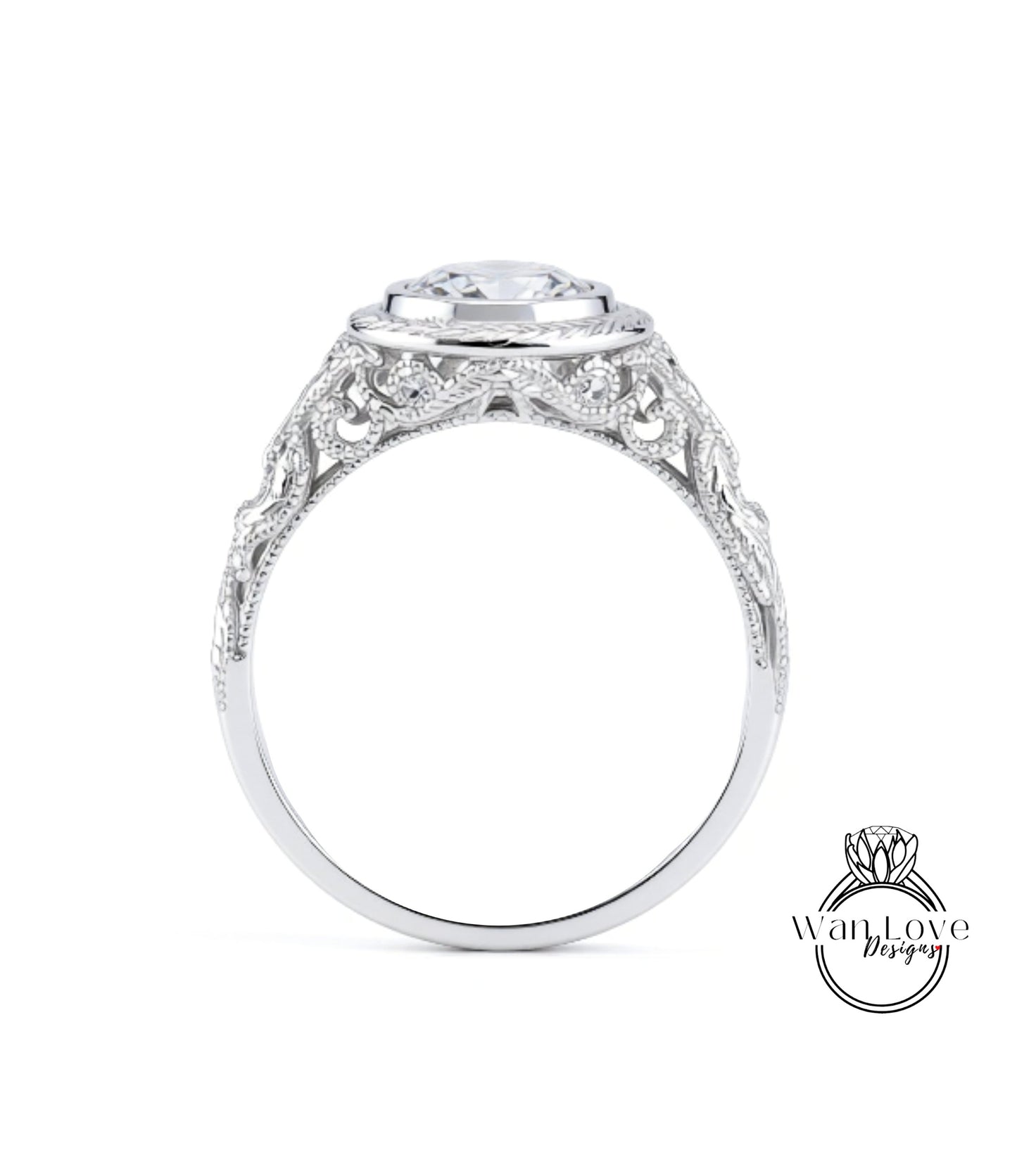 A close-up view of a silver ring with an intricate, decorative design around the band and a large central stone.