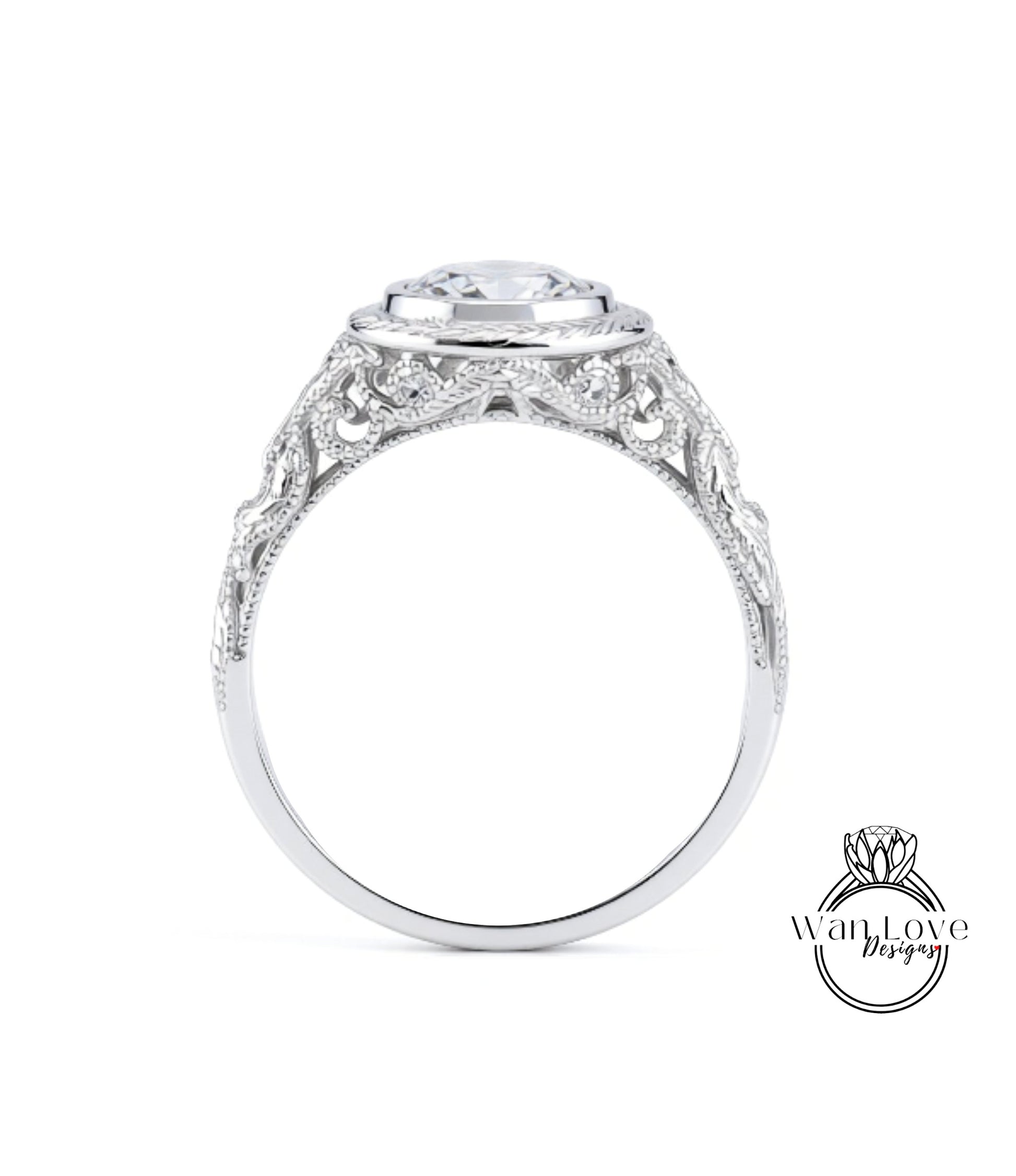 A close-up view of a silver ring with an intricate, decorative design around the band and a large central stone.