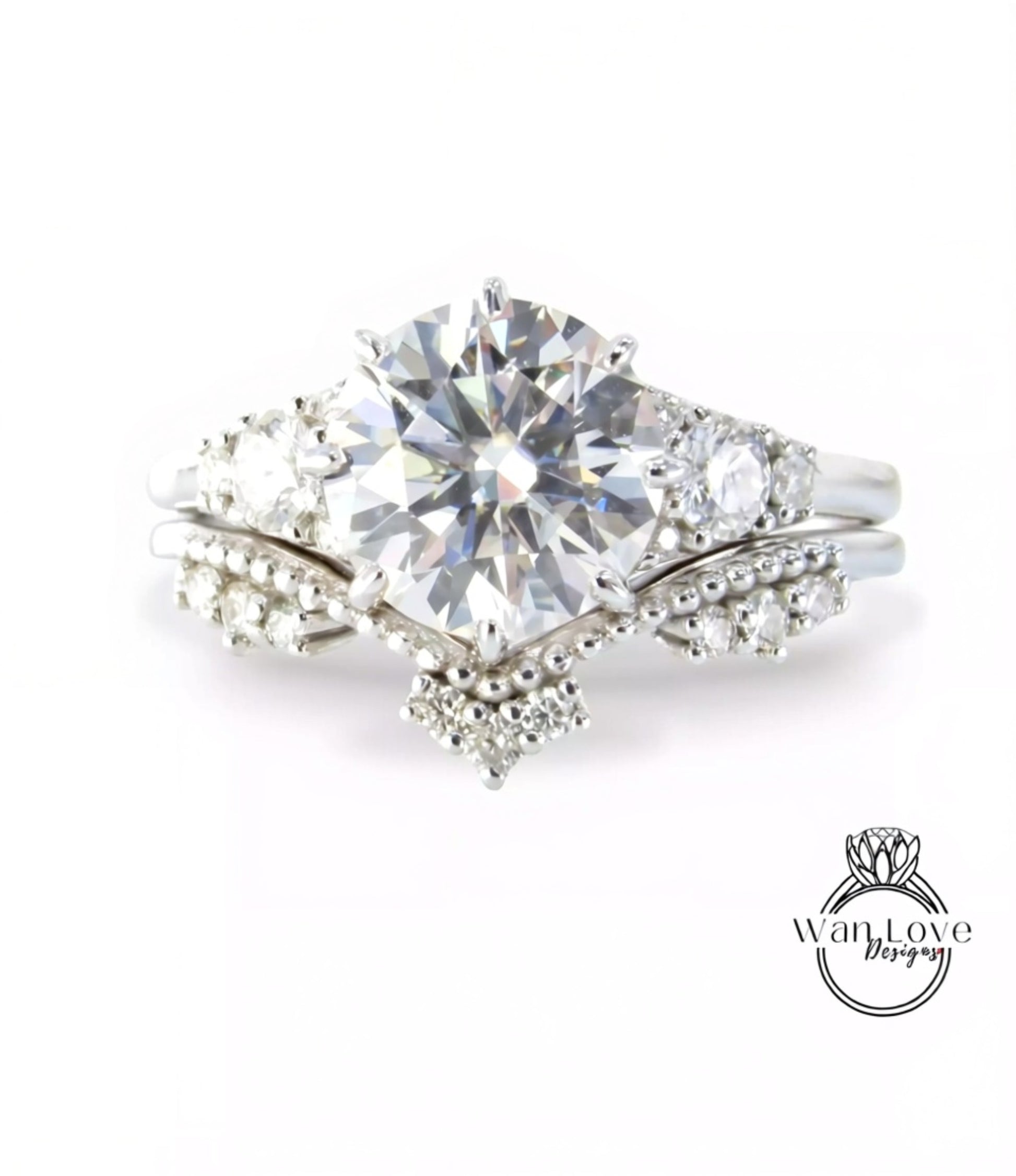 A close-up view of a diamond engagement ring with a large central diamond surrounded by smaller diamonds and a halo of smaller diamonds on either side.