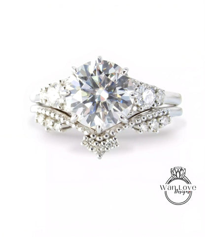 A close-up view of a diamond engagement ring with a large central diamond surrounded by smaller diamonds and a halo of smaller diamonds on either side.