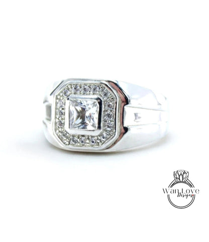 A silver ring with a large, clear gemstone set in the center.