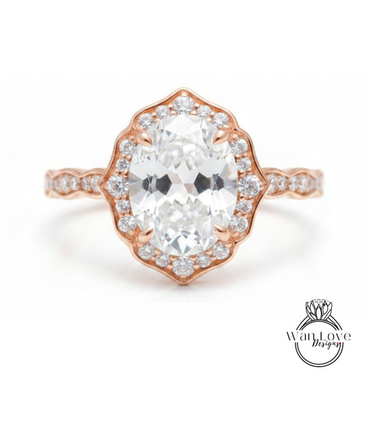 a beautiful diamond engagement ring with a large oval-shaped diamond set in a halo of smaller diamonds, all encircled by a delicate gold band.