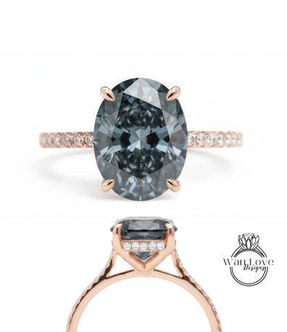 a beautiful engagement ring with a large oval-shaped blue diamond set in a rose gold band. The ring is adorned with small diamonds around the band, adding to its elegance and sophistication.