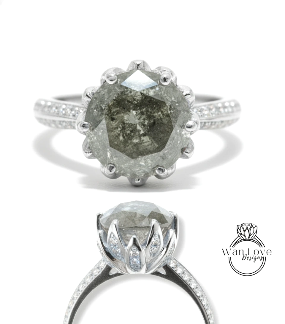 A silver ring with a large, irregularly shaped diamond as the centerpiece. The ring is set with smaller diamonds around the band, creating a sparkling effect.