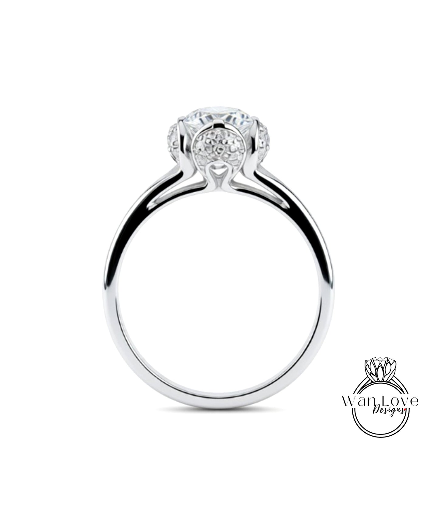 A silver engagement ring with a large central diamond surrounded by smaller diamonds.