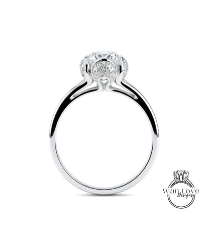 A silver engagement ring with a large central diamond surrounded by smaller diamonds.