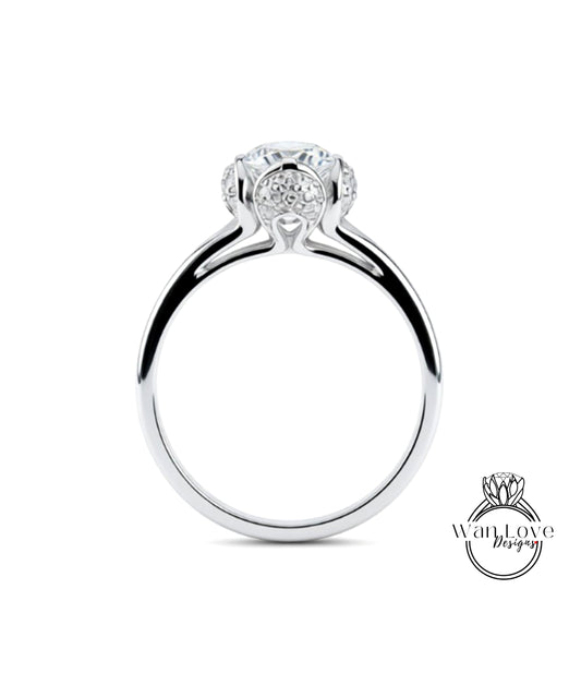 A silver engagement ring with a large central diamond surrounded by smaller diamonds.