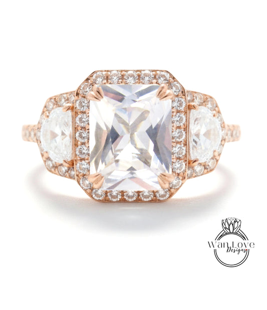 A large, clear gemstone ring with a halo of smaller diamonds around the center stone.