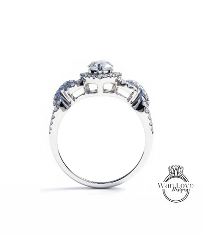 A silver engagement ring with a large central diamond surrounded by smaller diamonds on either side.