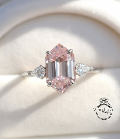 A close-up image of a diamond engagement ring with a large, pink gemstone set in a silver band.