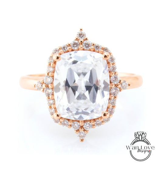 A large, clear gemstone ring with a halo of smaller diamonds around the center stone.