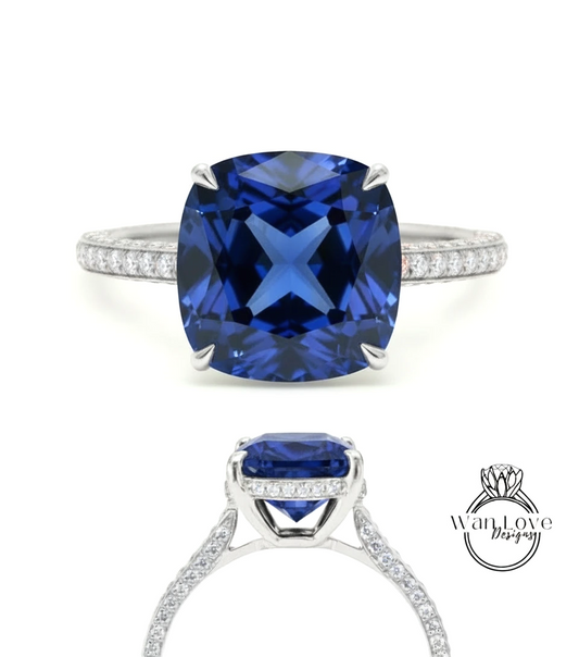 A stunning blue gemstone engagement ring with a large, square-cut sapphire set in a silver band adorned with small diamonds.
