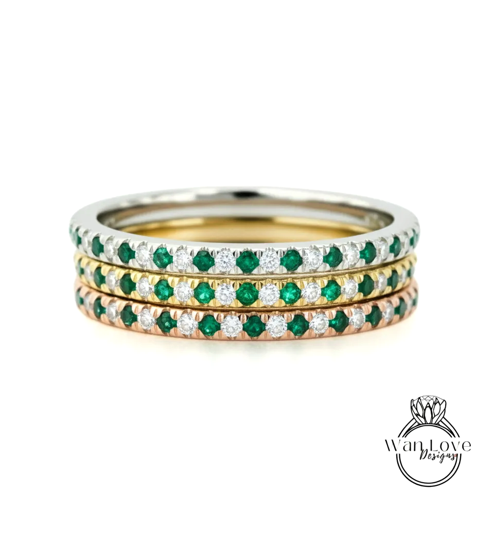 A stack of three rings with green and white gemstones set in a silver band.