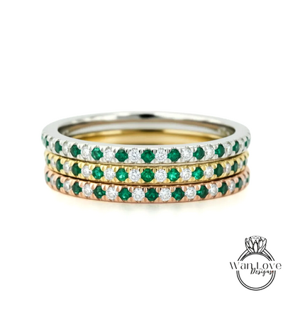 A stack of three rings with green and white gemstones set in a silver band.
