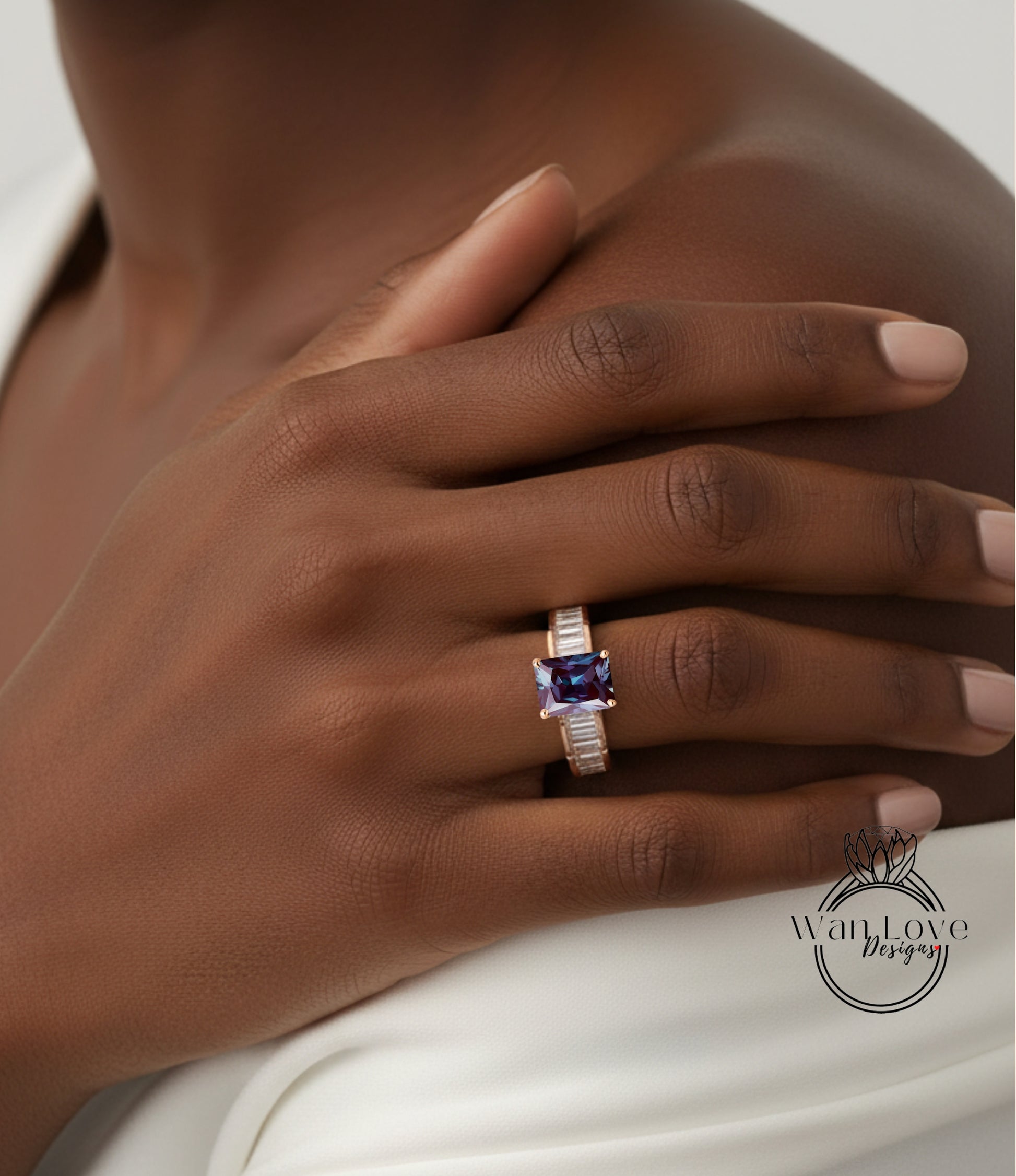 A close-up of a person's hand wearing a ring with a purple gemstone.