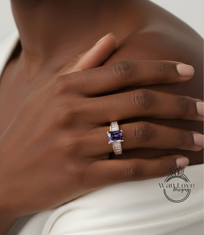 A close-up of a person's hand wearing a ring with a purple gemstone.