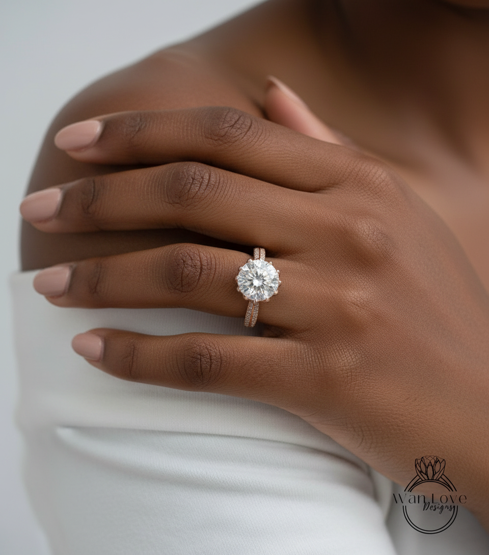 A close-up of a person's hand wearing a large, sparkling diamond engagement ring on the ring finger.