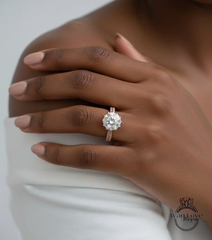 A close-up of a person's hand wearing a large, sparkling diamond engagement ring on the ring finger.
