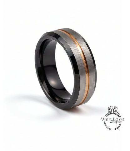 A modern ring with a black and silver band, featuring a thin gold stripe across the middle.