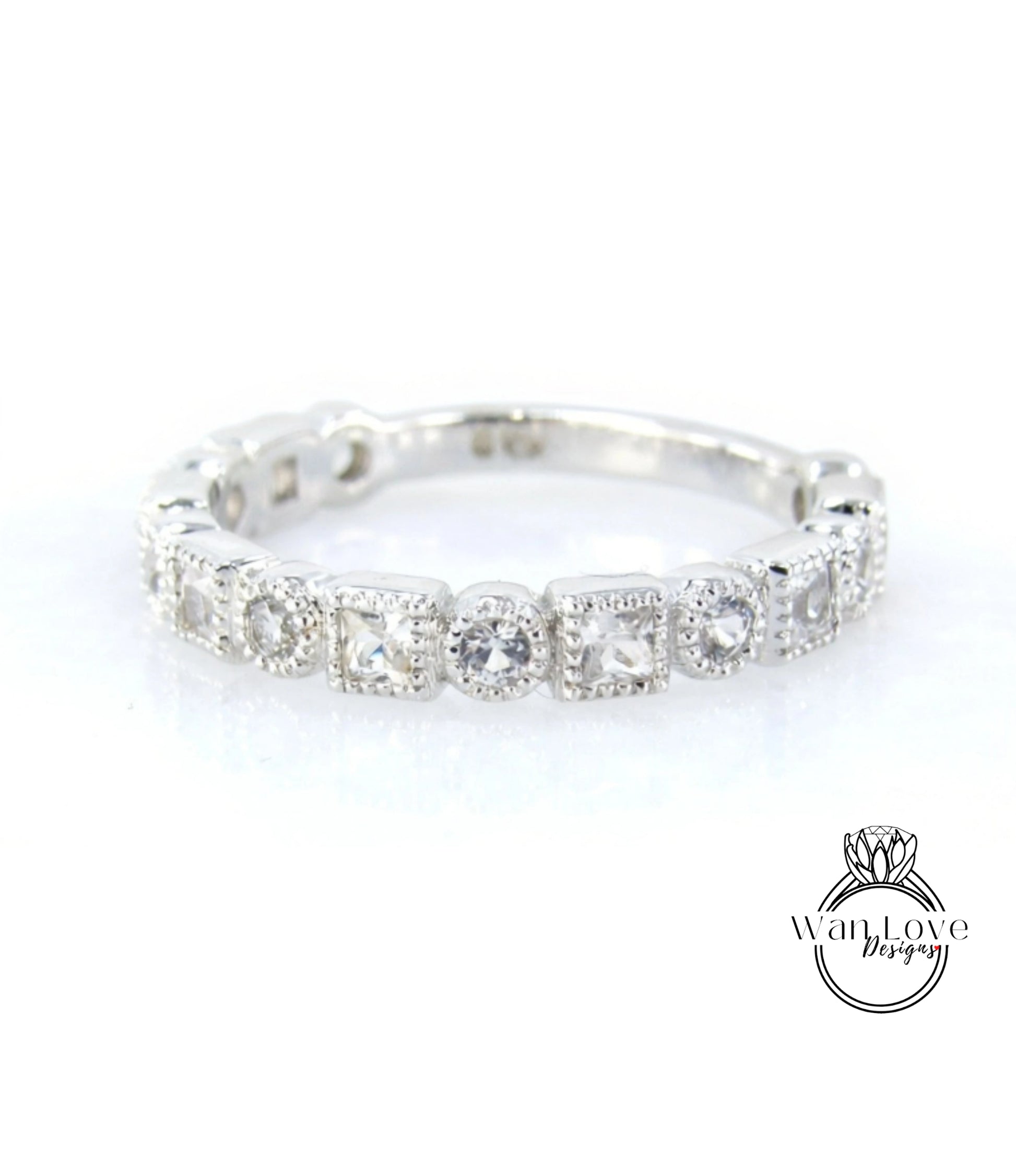 A silver ring with a row of small diamonds set in the center.