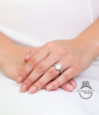 A close-up of a person's hands wearing a large, white diamond engagement ring.