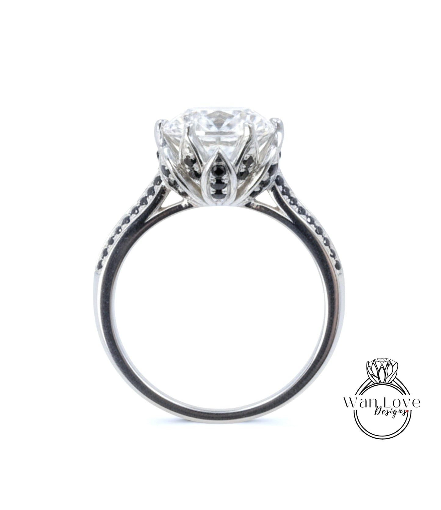 A close-up view of a silver engagement ring with a large central diamond surrounded by smaller diamonds and a floral-inspired design.