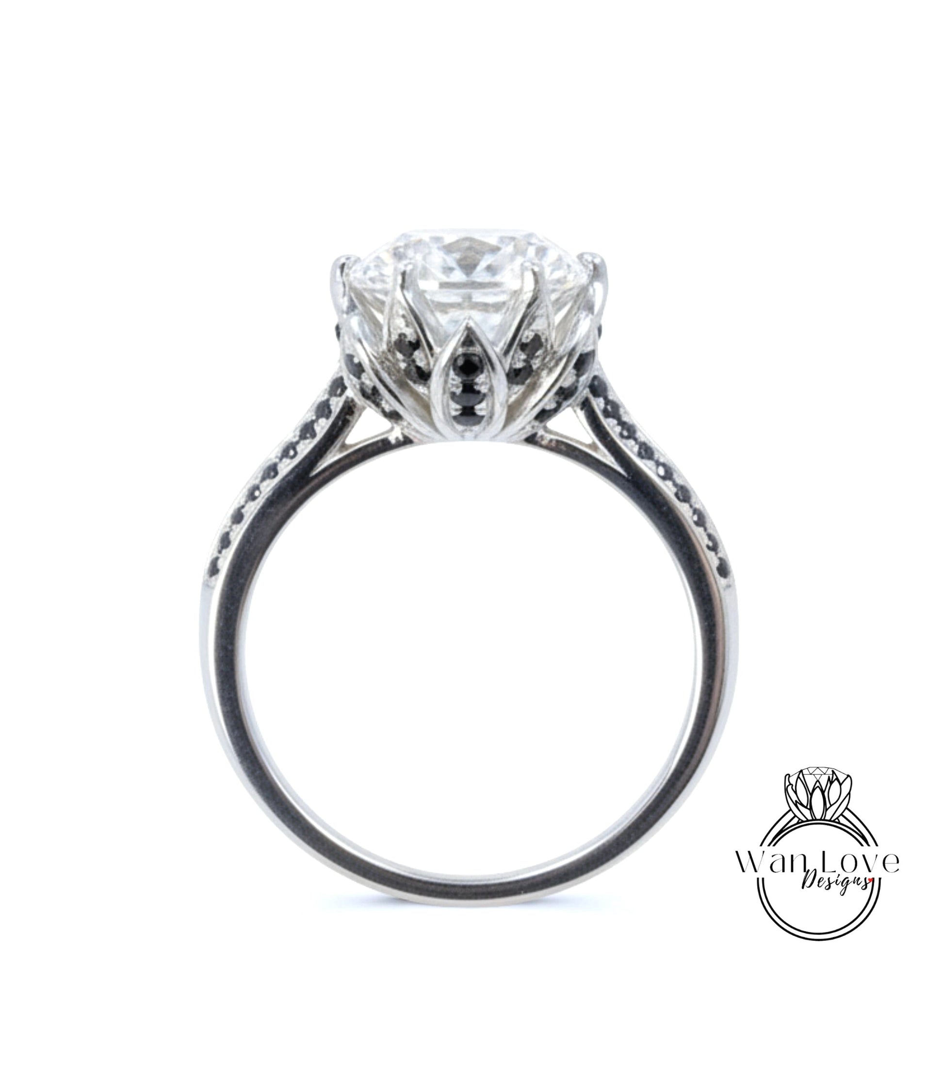 A close-up view of a silver engagement ring with a large central diamond surrounded by smaller diamonds and a floral-inspired design.