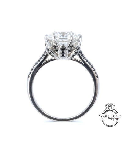 A close-up view of a silver engagement ring with a large central diamond surrounded by smaller diamonds and a floral-inspired design.
