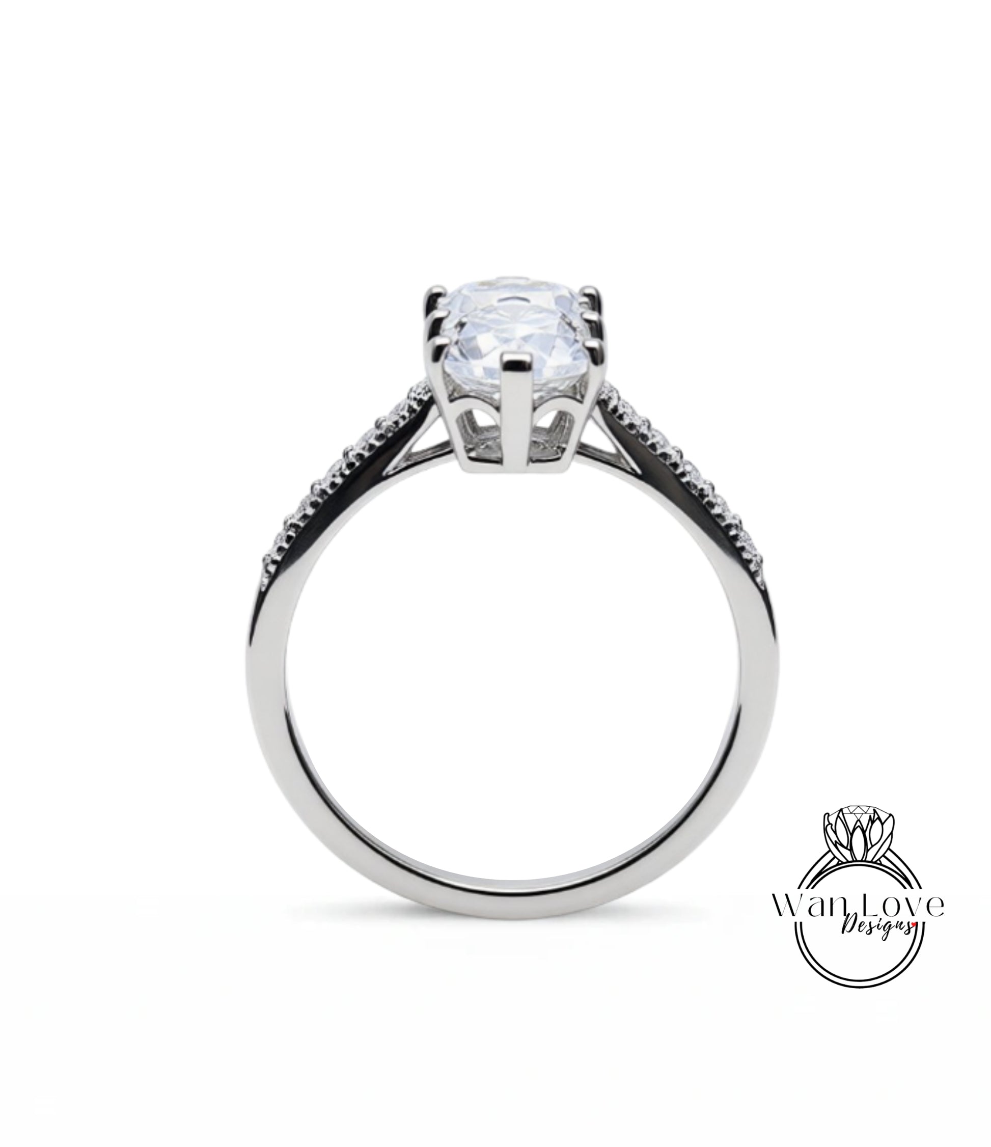 A silver engagement ring with a large, clear gemstone set in the center.
