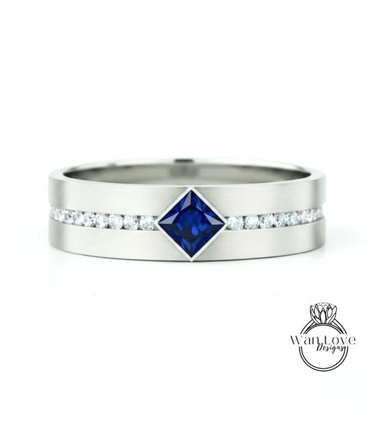 A silver ring with a blue gemstone in the center, surrounded by small diamonds.