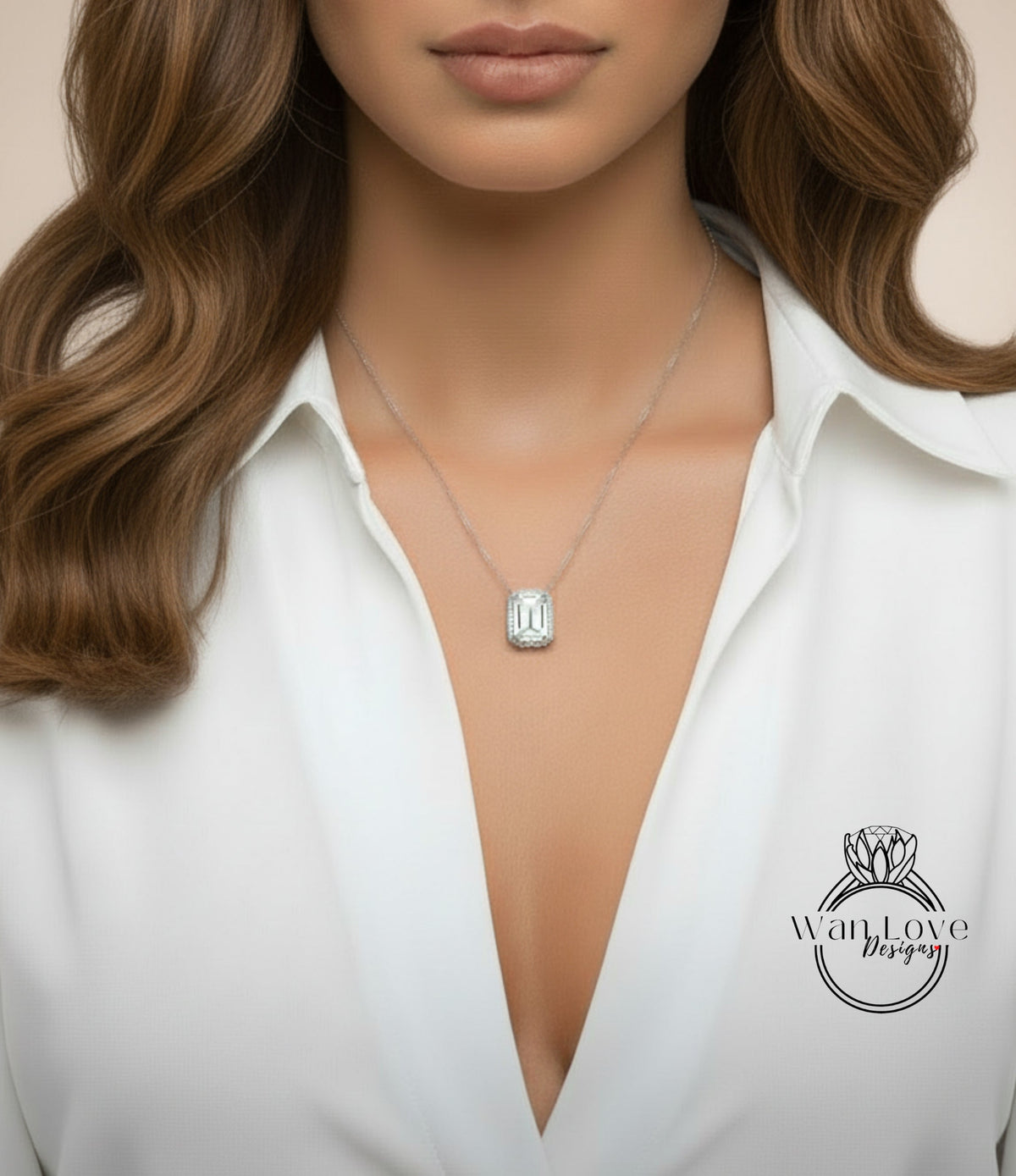 A close-up of a woman wearing a white blouse with a necklace featuring a large diamond pendant.