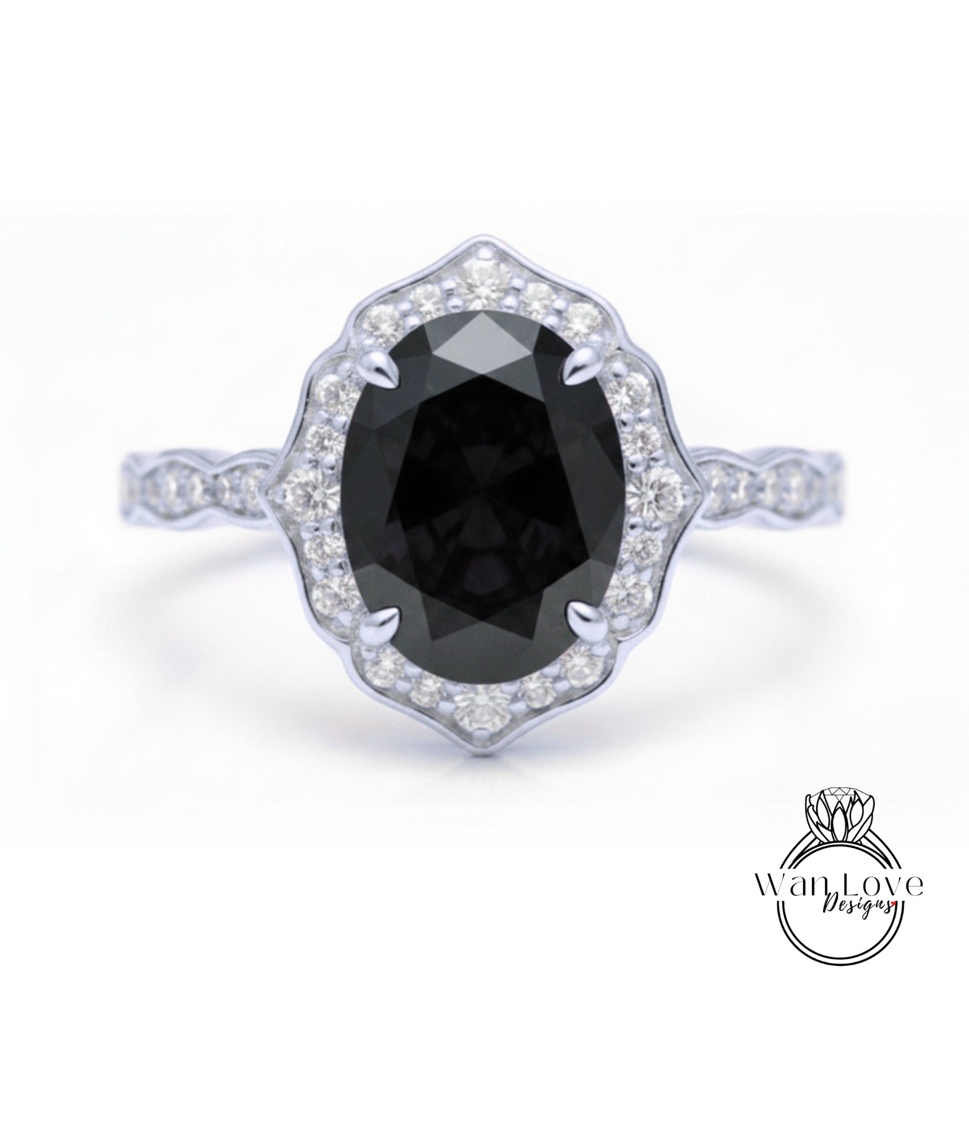 A silver ring with a large oval-shaped black gemstone at the center, surrounded by smaller diamonds.