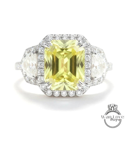 A stunning yellow gemstone ring with a halo of diamonds around it, set in a silver band.