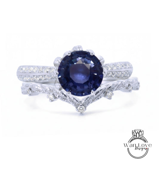 A close-up view of a silver ring with a large blue gemstone, possibly a sapphire, set in a decorative band.