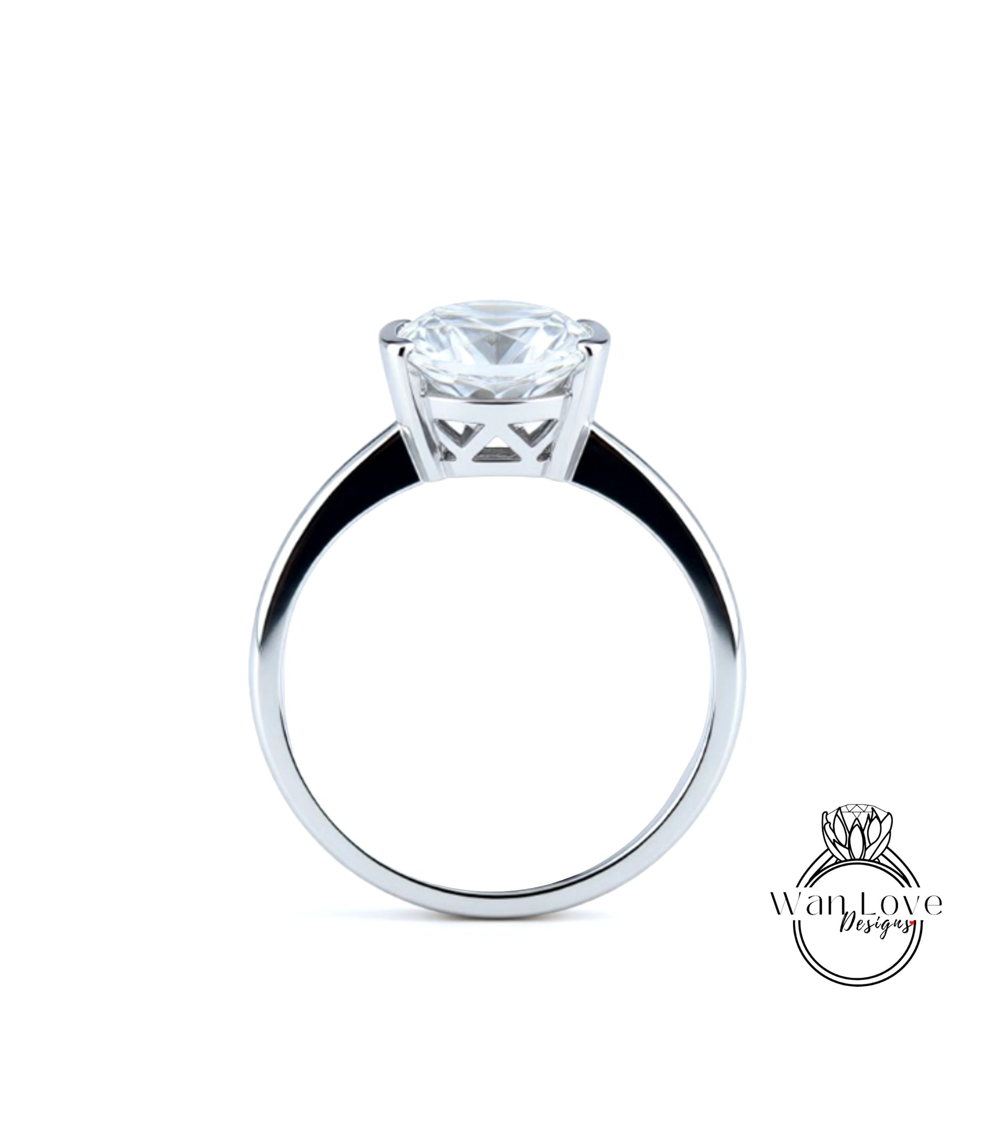 A silver engagement ring with a large, clear diamond set in the center of the band.