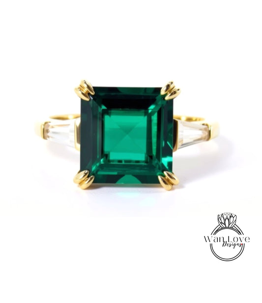 A large, square-cut green gemstone set in a gold ring.